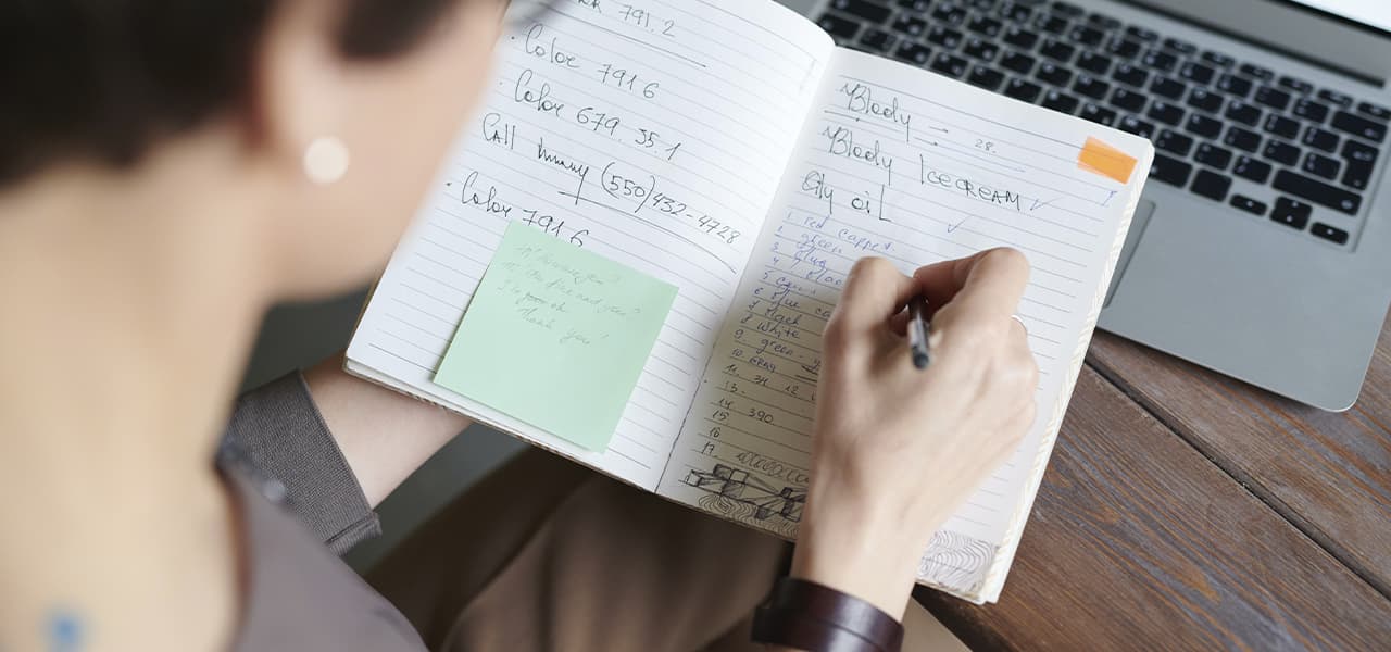 A girl writes in her notebook